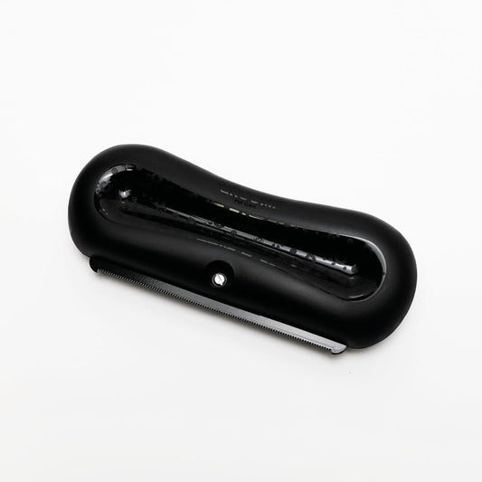 Stainless steel wide shallow comb on Groomi pet shedding brush close up