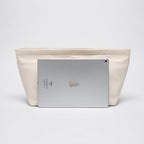 Lightweight canvas travel bag organizer being lifted out of a tote purse for quick swapping