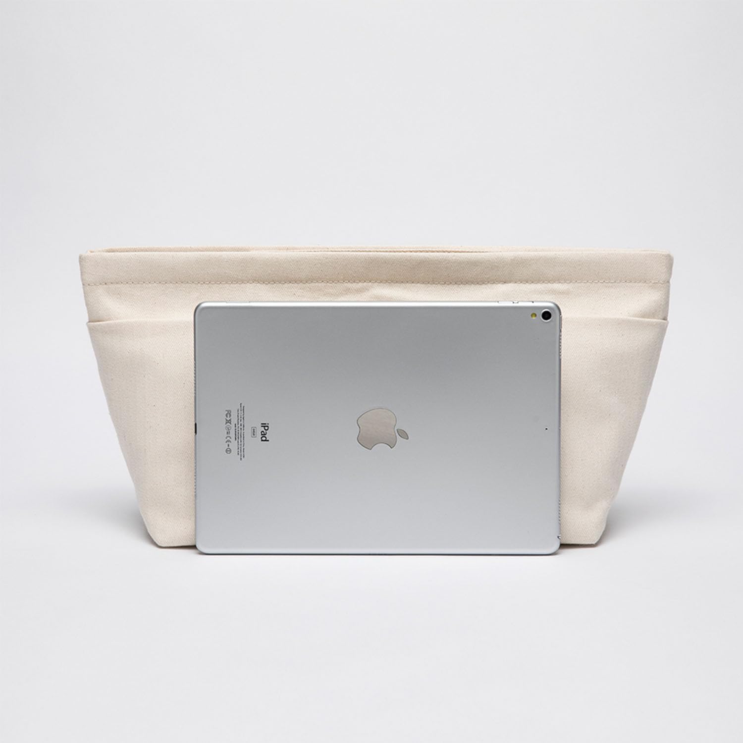 Lightweight canvas travel bag organizer being lifted out of a tote purse for quick swapping
