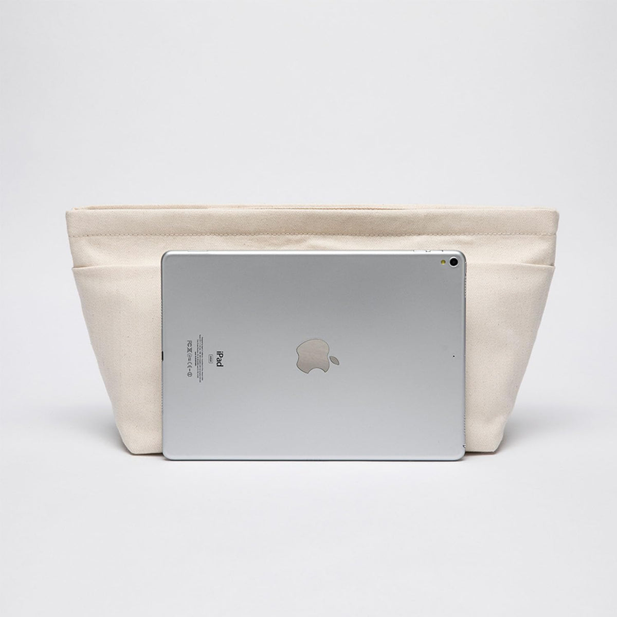 Lightweight canvas travel bag organizer being lifted out of a tote purse for quick swapping