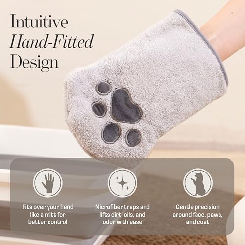 Hand wearing Muddi Pet grooming glove cleaning a dog paw