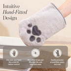 Hand wearing Muddi Pet grooming glove cleaning a dog paw