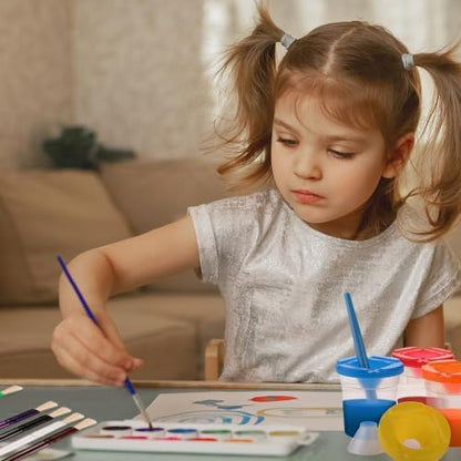 Spill proof painting containers with matching colored lids and thick plastic toddler brushes arranged on a white activity table