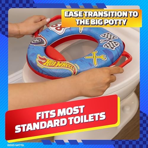 Hot Wheels toddler toilet seat hanging neatly on a bathroom wall using the included storage hook.
