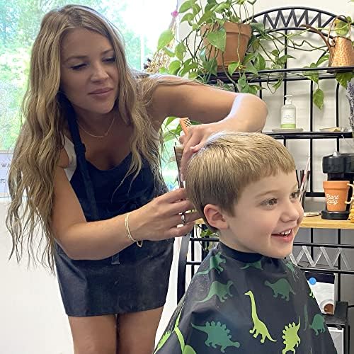 Full length view of the 27 by 36 inch children hair cutting cape draping over a chair.