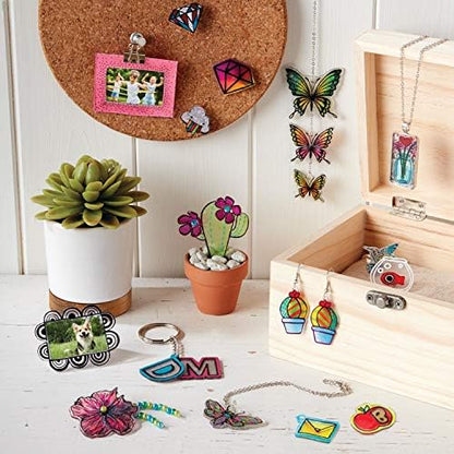 Crystal clear plastic shrink sheets from the Shrinky Dinks kit laid out for tracing art projects.