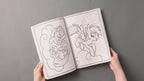 A child turning the pages of the imported character drawing book