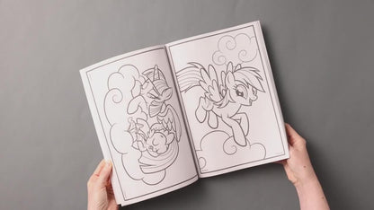 A child turning the pages of the imported character drawing book