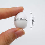 Close up of 26mm by 21mm plastic dummy eggs for cockatiels.