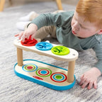 Toddler playing with Melissa and Doug Match and Push Spinning Tops toy