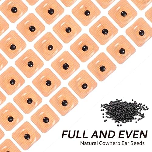 Close up of disposable ear press seeds on adhesive backing for acupressure.