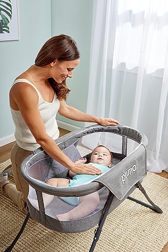 PRIMO folding travel bassinet fully assembled without the canopy for indoor use.