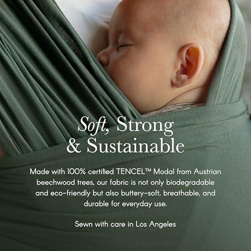 Ergonomic seating position of a toddler nestled securely inside the green Basil sling wrap.