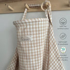 Detailed view of Tisu nursing cover fabric and wooden ring