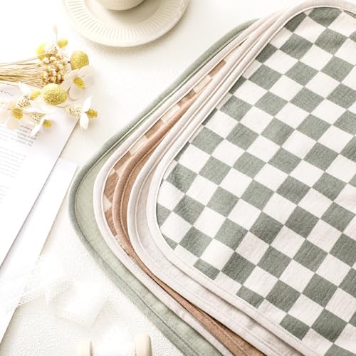 Stacked set of five reusable cotton change mats in neutral pastel tones