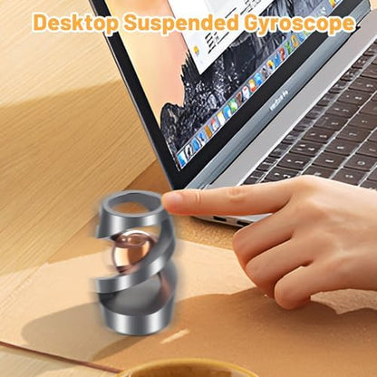 Hand holding the kinetic spinning desk fidget toy