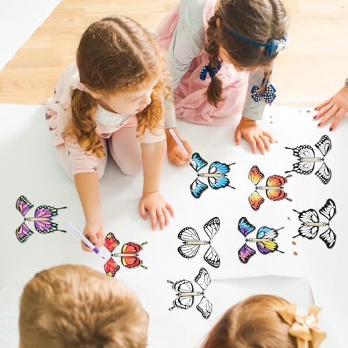 Children sharing and painting different styles of white butterfly cutouts at a table