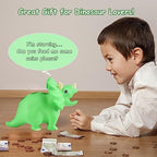 Top view of the green dinosaur coin bank emphasizing the wide deposit slot for currency.