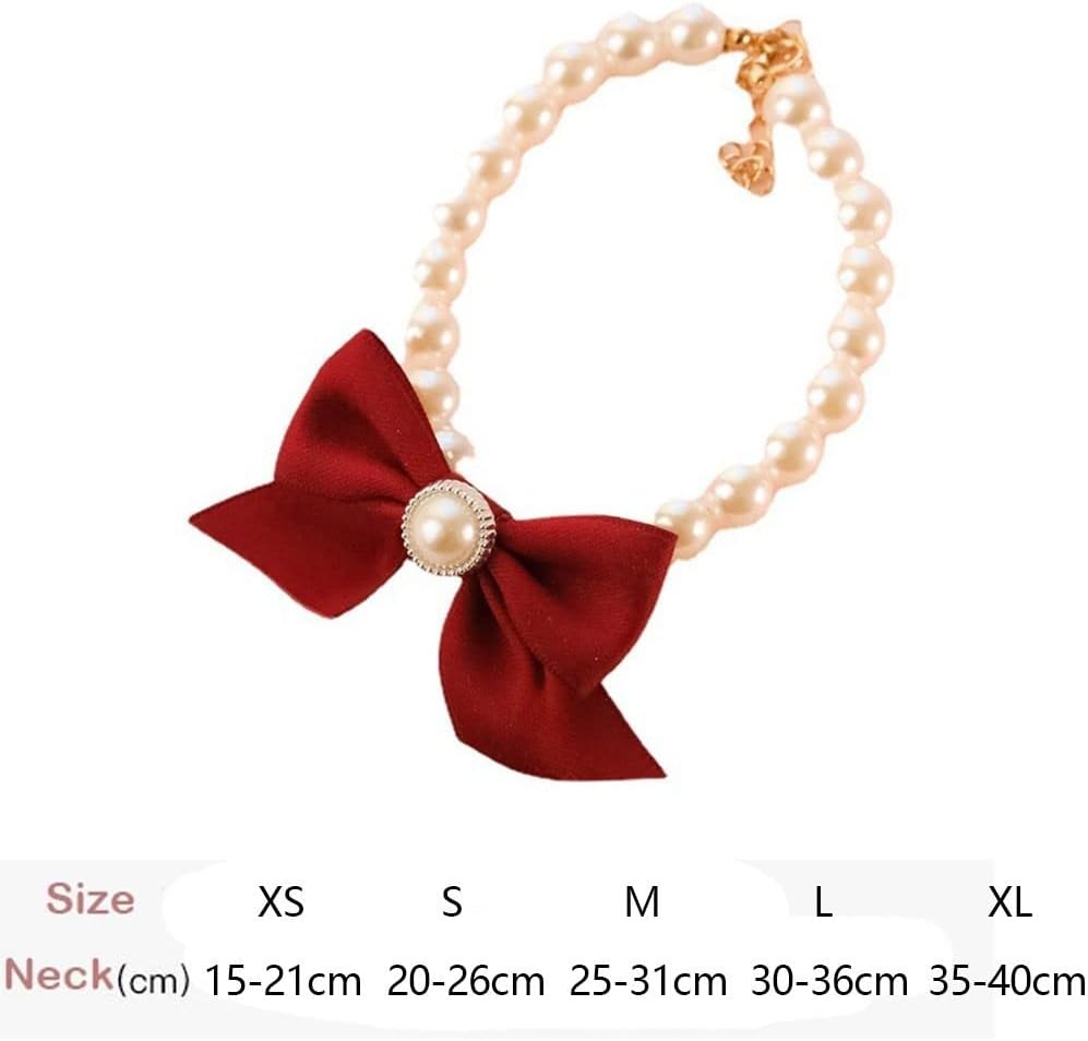 Close up view of adjustable faux pearl dog necklace with vibrant red ribbon bow tie.