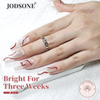 Hand applying Jodsone red swirl gel polish for French tip design
