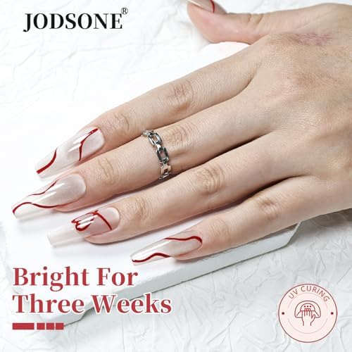 Hand applying Jodsone red swirl gel polish for French tip design