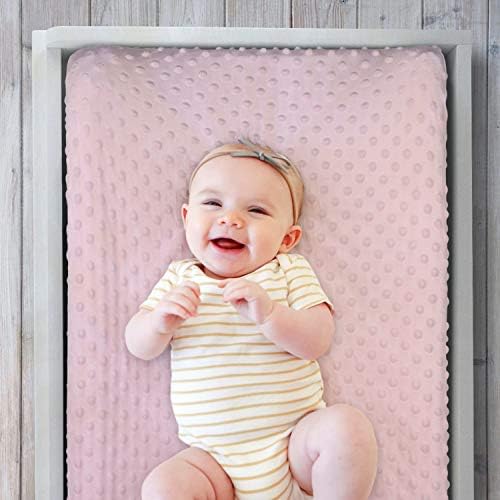 Close up view of the ultra soft pink minky dot textured fabric on the baby changing sheet