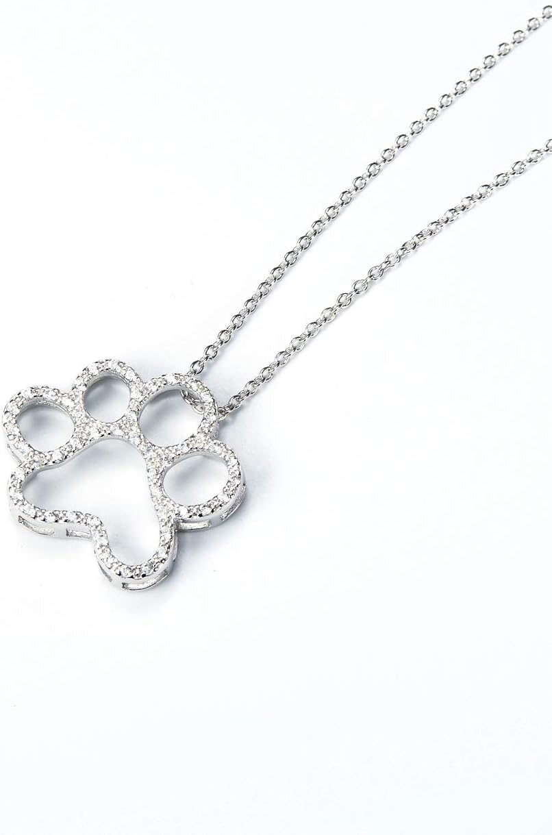 ONEFINITY sterling silver dog paw pendant with shimmering cubic zirconia stones close up view