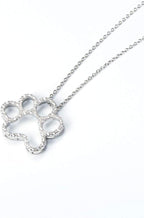 ONEFINITY sterling silver dog paw pendant with shimmering cubic zirconia stones close up view