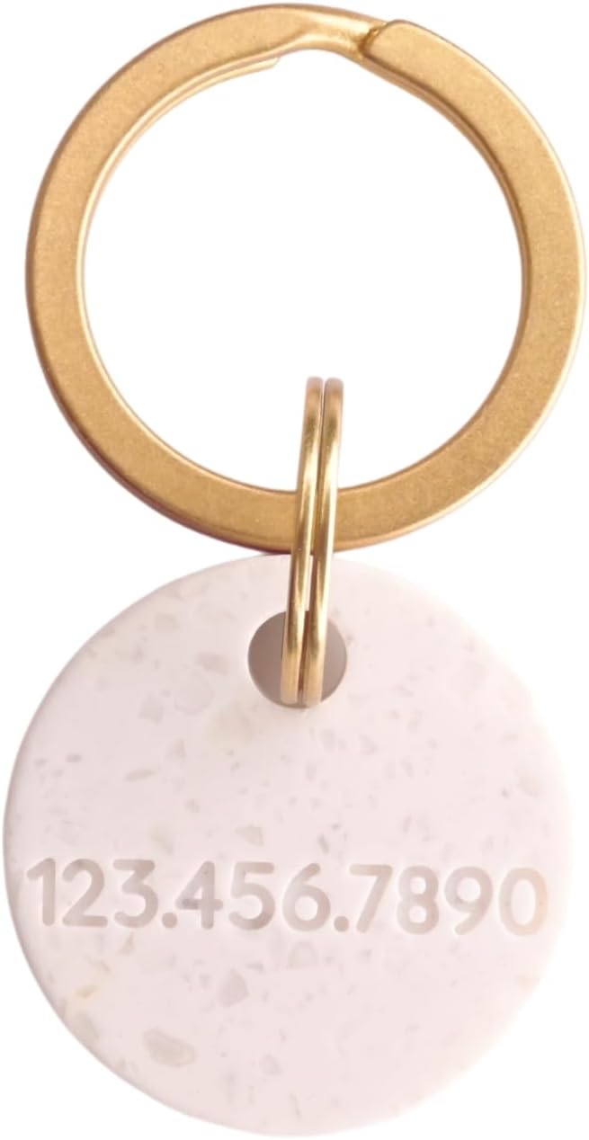 Onoma minimalist circular terrazzo style dog tag on a brass ring.