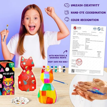 Child painting a colorful geometric design onto the kitty lamp