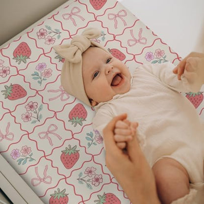 Baby changing pad cover styled on a nursery changing table