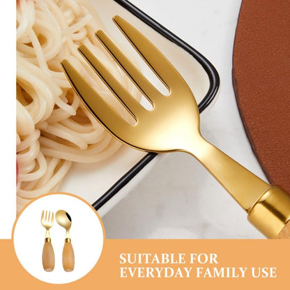 Toddler using Pretyzoom stainless steel silverware with wooden handles