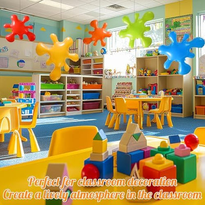 Five multi-colored blow up paint splash props arranged as a creative classroom wall decoration kit.