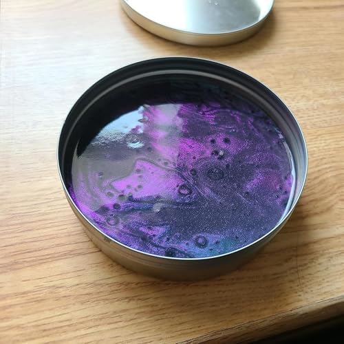 A person stretching the iridescent purple and blue sensory putty to show its flexible texture.