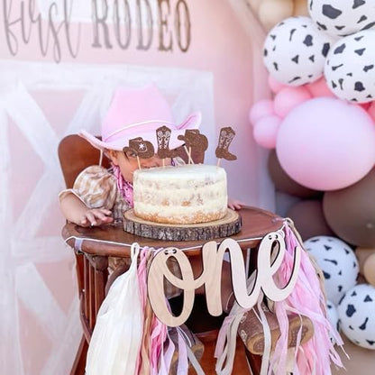 Decorative cupcake toppers arranged for a western themed baby shower.