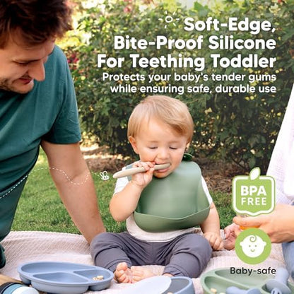 BPA free food grade silicone baby spoons laid out on a kitchen table.