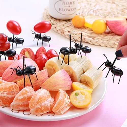 Ant shaped fruit forks arranged on a fruit platter