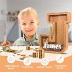 Side angle of the large alphabet initial money box showcasing the thick natural pine wood structure.