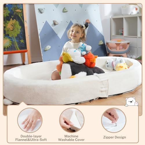 BUMNANA children travel bed with the matching blanket laid out neatly inside the safety bumpers.