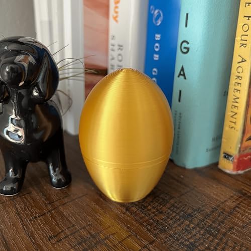 Adult Easter basket stuffer gold prank egg held in hand for scale