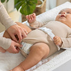 Ingenuity baby changing pad showing high curved safety walls and safety belt