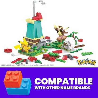 Poseable Pikachu figure standing on the green grass section of the MEGA building toy kit.