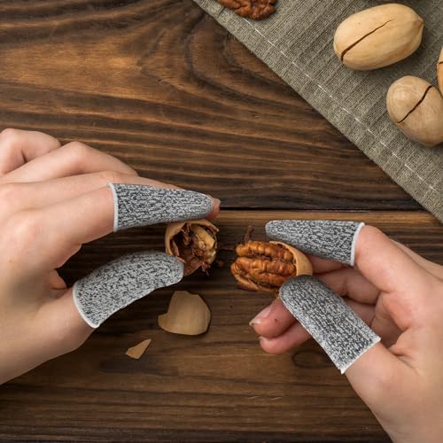 Close up of level 5 cut resistant fabric finger sleeve protector worn on a thumb during kitchen use