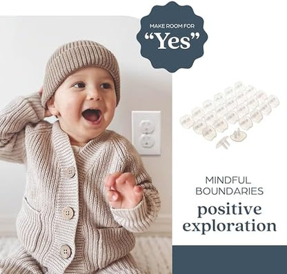 Transparent Dreambaby safety plug being inserted into wall socket