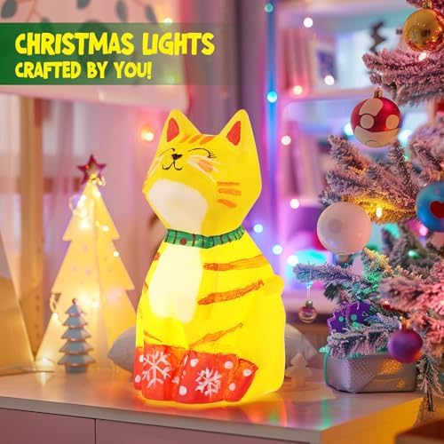 The finished custom painted cat lamp glowing softly on a bedroom nightstand in the dark.