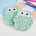 Close up view of the embossed ABC letters on the green silicone popping bubbles for educational learning.