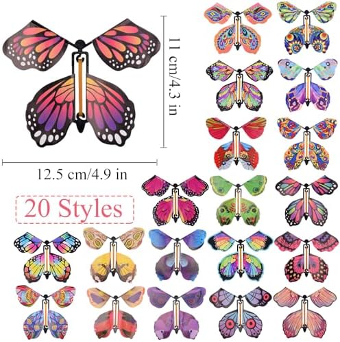 Close up view of winding the rubber band mechanism on a colorful wind up paper butterfly toy