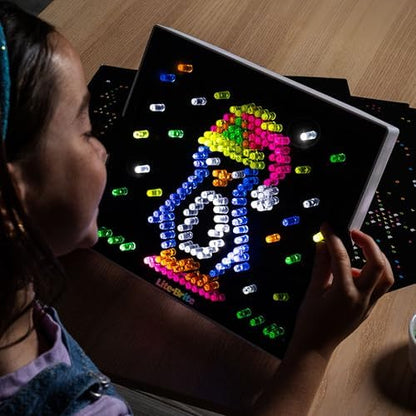 Lite Brite toy illuminating a dark room to showcase the four dynamic color changing LED flashing modes and neon effect.