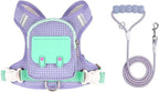 Small dog wearing pink reflective harness backpack in outdoor setting