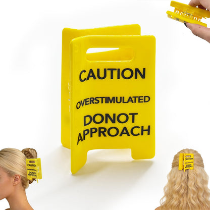 Generic overstimulated caution sign hair claw clip front view showing yellow wet floor sign design.